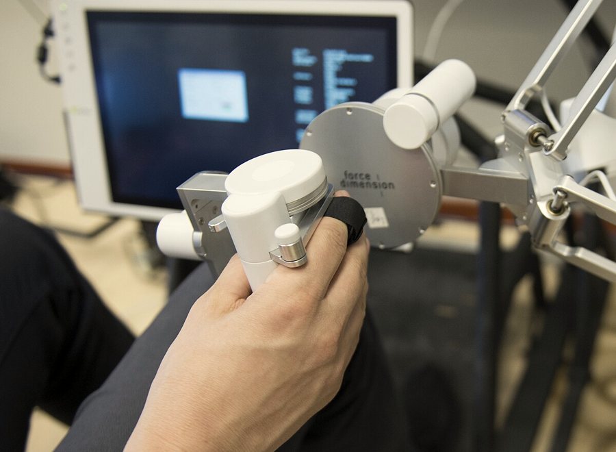 Operator hand on a haptic teleoperation controller